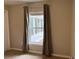 Bedroom features a window with curtains overlooking the yard at 20386 Sw 95Th St, Dunnellon, FL 34431