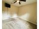 A standard carpeted bedroom offers a ceiling fan, a wall-mounted TV and neutral wall color at 20386 Sw 95Th St, Dunnellon, FL 34431