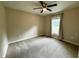 Bedroom features a large window with curtains and neutral carpet at 20386 Sw 95Th St, Dunnellon, FL 34431