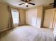 Bedroom features a ceiling fan, a window with curtains, and a double closet at 20386 Sw 95Th St, Dunnellon, FL 34431