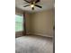 Bedroom featuring carpeted floors and a bright window with neutral curtains at 20386 Sw 95Th St, Dunnellon, FL 34431