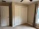 Bedroom featuring carpeted floors, window and closet at 20386 Sw 95Th St, Dunnellon, FL 34431