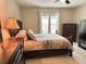 Comfortable bedroom with bed, dresser, windows and soft natural light at 20386 Sw 95Th St, Dunnellon, FL 34431