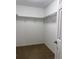 Empty walk in closet with carpet and wire shelving and an open door at 20386 Sw 95Th St, Dunnellon, FL 34431