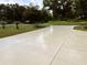 This property features a long and wide concrete driveway with parking for multiple vehicles at 20386 Sw 95Th St, Dunnellon, FL 34431