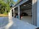 Metal building with open garage doors showcasing its spacious interior at 20386 Sw 95Th St, Dunnellon, FL 34431