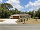 Beautiful single-story home with a well-manicured lawn and a freshly sealed driveway at 20386 Sw 95Th St, Dunnellon, FL 34431