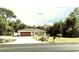 Charming single-story home featuring an attached garage, landscaped yard, and flag pole at 20386 Sw 95Th St, Dunnellon, FL 34431