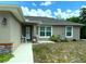 Charming front exterior with stylish door, landscaped garden bed, healthy grass, and cozy curb appeal at 20386 Sw 95Th St, Dunnellon, FL 34431
