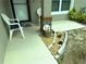 Cozy front porch with chairs and landscaping, perfect for relaxing and enjoying the outdoors at 20386 Sw 95Th St, Dunnellon, FL 34431