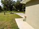 This property features a front yard with a long concrete driveway and grassy areas at 20386 Sw 95Th St, Dunnellon, FL 34431