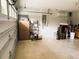 View of the open garage with speckled epoxy flooring, storage cabinet, and insulated garage door at 20386 Sw 95Th St, Dunnellon, FL 34431