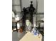 Garage interior featuring an air compressor, shop vac and work tables at 20386 Sw 95Th St, Dunnellon, FL 34431