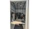View of garage interior with metal framework, storage shelves, and concrete flooring at 20386 Sw 95Th St, Dunnellon, FL 34431