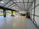 Spacious garage featuring high ceilings, ample storage, and smooth concrete flooring at 20386 Sw 95Th St, Dunnellon, FL 34431