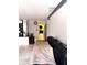 A garage with speckled floors leads to a room through an open door at 20386 Sw 95Th St, Dunnellon, FL 34431