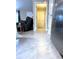 Hallway view with tile floor leading to living area with recliner, tile and stainless steel appliances at 20386 Sw 95Th St, Dunnellon, FL 34431