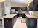 Modern kitchen design featuring stainless steel appliances, dark cabinetry, and granite countertops at 20386 Sw 95Th St, Dunnellon, FL 34431