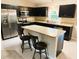Modern kitchen with stainless steel appliances, island with seating, and plenty of counter space at 20386 Sw 95Th St, Dunnellon, FL 34431