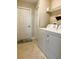 Standard laundry room with washer and dryer, white door, and tile floor at 20386 Sw 95Th St, Dunnellon, FL 34431