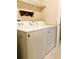Standard laundry room featuring washer and dryer, shelf, and tile floor at 20386 Sw 95Th St, Dunnellon, FL 34431