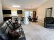 Open living space features a kitchen island, dining area, and comfortable living room furniture at 20386 Sw 95Th St, Dunnellon, FL 34431