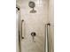 Walk-in shower with beige tile surround and dual safety grab bars at 20386 Sw 95Th St, Dunnellon, FL 34431