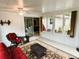 Bright sunroom features a ceiling fan, tile floors, and wicker furniture at 20386 Sw 95Th St, Dunnellon, FL 34431