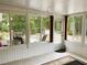 Bright sunroom featuring tile floors, white walls, and large windows at 20386 Sw 95Th St, Dunnellon, FL 34431