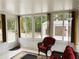 Sunroom with tile floors, wicker furniture, and large windows providing natural light at 20386 Sw 95Th St, Dunnellon, FL 34431