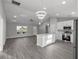 Stylish open-concept kitchen with stainless appliances, white cabinets, and adjacent living area at 20812 Sw Cardinal Ave, Dunnellon, FL 34431