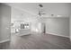 Bright open-concept living and kitchen area with sleek gray flooring and modern lighting fixtures at 20812 Sw Cardinal Ave, Dunnellon, FL 34431