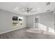 Spacious main bedroom with tray ceiling, ceiling fan, and a view into the ensuite bathroom at 20812 Sw Cardinal Ave, Dunnellon, FL 34431