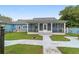 Charming screened-in porch offers a serene view of the lush backyard and vibrant landscaping at 20921 Sw 36Th St, Dunnellon, FL 34431