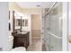 Clean bathroom featuring a vanity with storage, a mirror, and a modern glass-enclosed shower at 20921 Sw 36Th St, Dunnellon, FL 34431