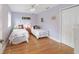 Cozy bedroom with hardwood floors, natural lighting, and twin beds with floral bedding at 20921 Sw 36Th St, Dunnellon, FL 34431