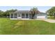 Charming home featuring a screened-in porch, light blue exterior, and lush green lawn at 20921 Sw 36Th St, Dunnellon, FL 34431