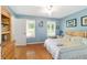 Serene bedroom with two windows, hardwood floors, and soft lighting, providing a calming and restful retreat at 20921 Sw 36Th St, Dunnellon, FL 34431