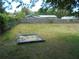 A spacious backyard featuring a wooden sandbox and partial fencing, with a grassy lawn at 2912 Ne 24Th Ct, Ocala, FL 34479