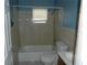 A well-lit bathroom featuring tiled walls, a shower-tub combination, and a coordinated toilet and sink at 2912 Ne 24Th Ct, Ocala, FL 34479