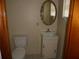 A cozy half bathroom featuring a sink and toilet at 2912 Ne 24Th Ct, Ocala, FL 34479
