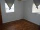 Bedroom with two windows and laminate flooring at 2912 Ne 24Th Ct, Ocala, FL 34479