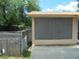View of the property's exterior, featuring a screened in porch and a wooden fence at 2912 Ne 24Th Ct, Ocala, FL 34479