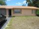 The exterior of a well-kept home featuring a metal roof, two windows with shutters and an open screened in porch at 2912 Ne 24Th Ct, Ocala, FL 34479