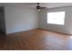 An open living room with laminate floors, a ceiling fan and a window with natural light at 2912 Ne 24Th Ct, Ocala, FL 34479