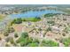 Panoramic aerial view of a residential community, with homes nestled beside a scenic lake surrounded by abundant trees at 347 Oak Lane Dr, Ocala, FL 34472