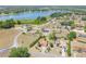 Expansive aerial view showcasing homes near a serene lake surrounded by lush greenery and mature trees at 347 Oak Lane Dr, Ocala, FL 34472