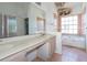 Bathroom with bathtub, large mirror, and double vanity at 347 Oak Lane Dr, Ocala, FL 34472