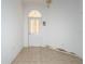 Entryway with an arched doorway, neutral tile flooring, and white painted walls at 347 Oak Lane Dr, Ocala, FL 34472