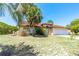 Charming single-Gathering home boasts a terracotta-tiled roof, complemented by palm trees and a spacious two-car garage at 347 Oak Lane Dr, Ocala, FL 34472